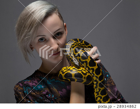 Blond smiling woman holding anaconda 28934862
