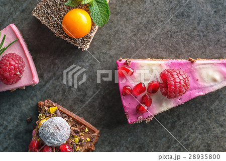 raw vegan cakes with fruit and seeds, decorated 28935800