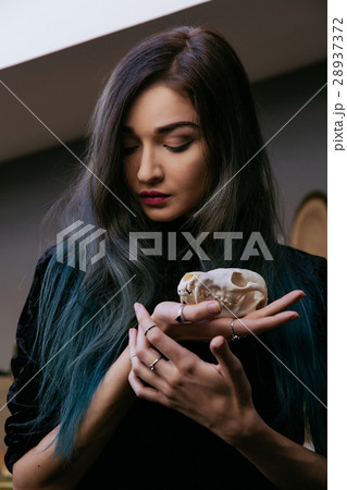 Portrait of a young girl holding a mysterious 28937372