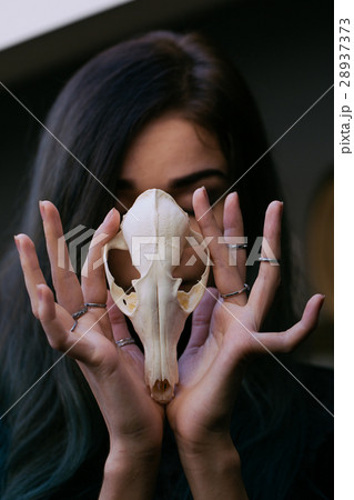 Portrait of a young girl holding a mysterious Portrait of a young girl holding a mysterious 28937373