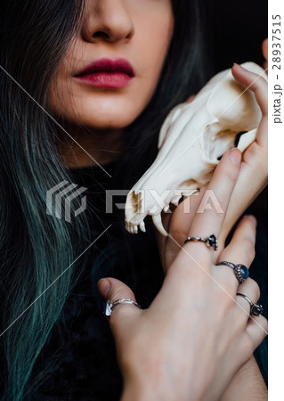 Portrait of a young girl holding a mysterious Portrait of a young girl holding a mysterious 28937515