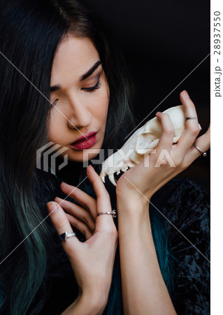 Portrait of a young girl holding a mysterious Portrait of a young girl holding a mysterious 28937550