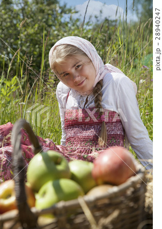 Little girl sitting in a meadow 28940247