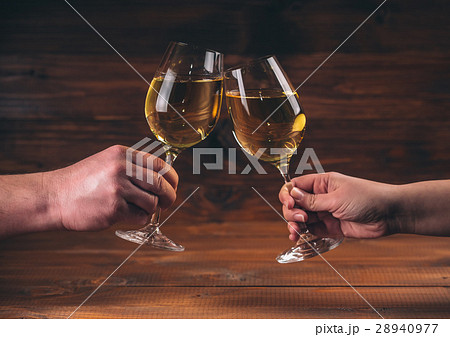 Hands of man and woman cheering with glasses  28940977