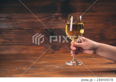 Woman hand cheering with glasses of white wine  28940978