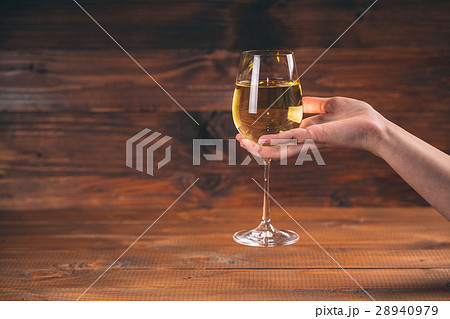 Woman hand cheering with glasses of white wine  28940979
