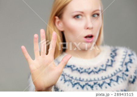 Woman making stop gesture with open hand 28943515