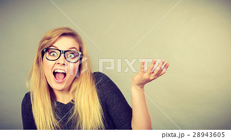 Nerdy woman in eyeglasses being confused Nerdy woman in eyeglasses being confused 28943605