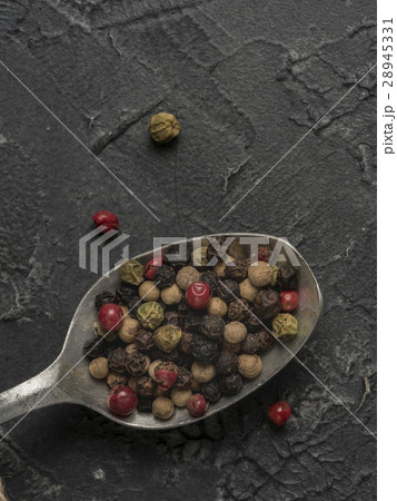 Colorful peppercorn in spoon on gray background Colorful peppercorn in spoon on gray background 28945331