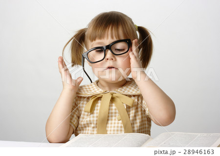 Little girl with books wearing black glasses 28946163