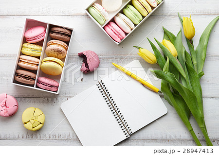 Feminine workspace with macarons and tulips Feminine workspace with macarons and tulips 28947413