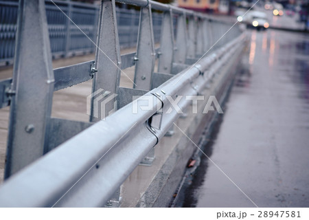 railing near the wet road 28947581