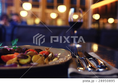 Serving a glass of red wine in a restaurant 28950895