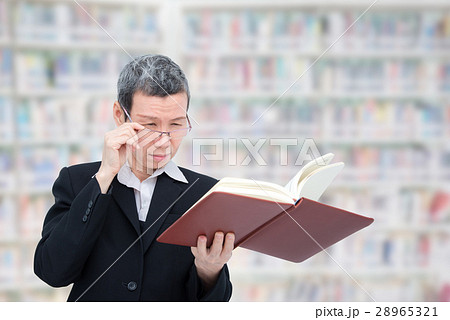 woman reading book having problem with her eyes 28965321