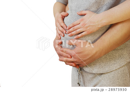 Happy young couple showing heart on belly of pregn 28973930