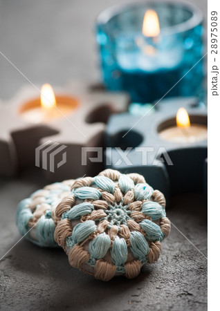 blue crochet stones and lit candles 28975089