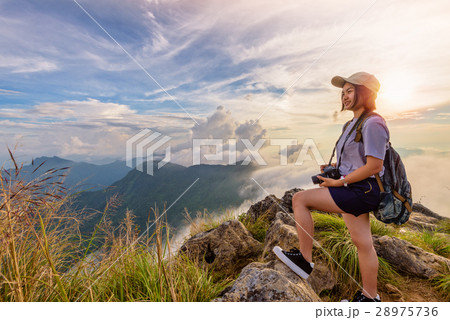 Girl tourist on mountains at sunset Girl tourist on mountains at sunset 28975736