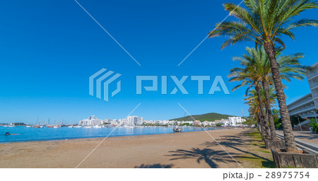 Man heads toward abandoned sailboat on the beach. 28975754