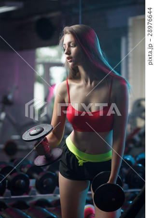 Beautiful girl doing workout with dumbbells 28976644