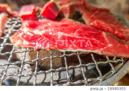 Japanese style Raw fresh beef on hot barbecue grill . 28980303