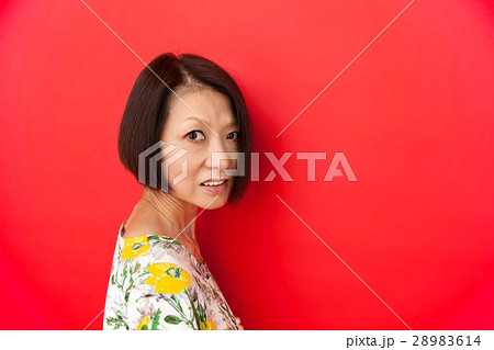 ショートボブの中年女性　赤背景 28983614