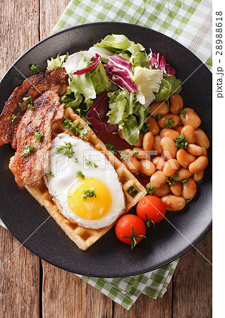 hearty breakfast with fried egg, waffles, bacon 28988618