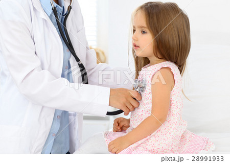 Doctor examining a little girl by stethoscope Doctor examining a little girl by stethoscope 28991933