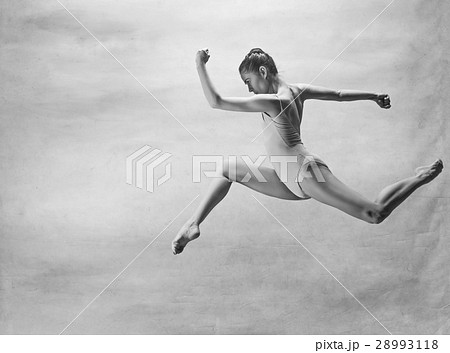 Young beautiful modern style dancer jumping on a Young beautiful modern style dancer jumping on a 28993118
