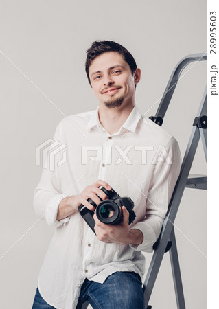 successful professional photographer use DSLR 28995603