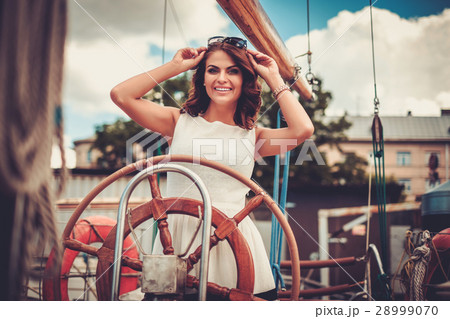 Stylish wealthy woman on a luxury wooden regatta Stylish wealthy woman on a luxury wooden regatta 28999070