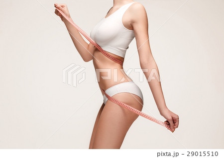 The girl taking measurements of her body, white 29015510