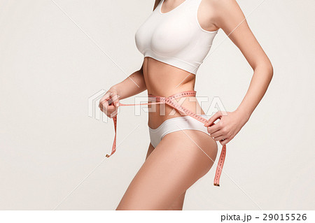 The girl taking measurements of her body, white 29015526