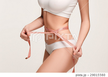 The girl taking measurements of her body, white 29015560