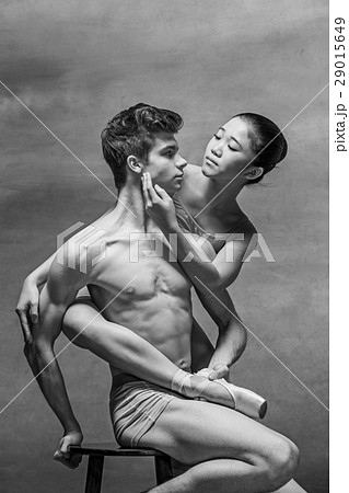 Couple of ballet dancers posing over gray Couple of ballet dancers posing over gray 29015649