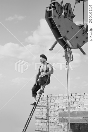 Retro construction worker climbing a ladder while 29016114