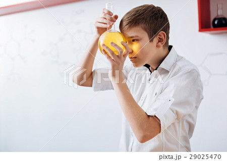Curious smart boy looking at the chemical agent Curious smart boy looking at the chemical agent 29025470