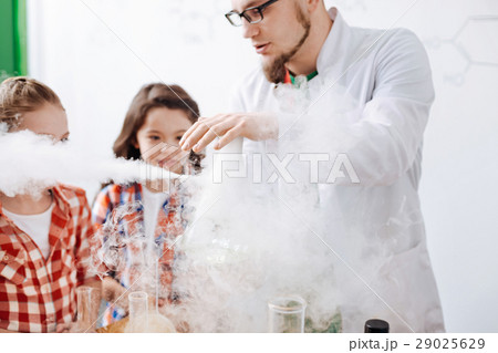 Serious experienced scientist performing a 29025629