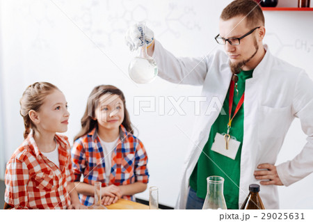 Serious thoughtful man looking at the liquid in Serious thoughtful man looking at the liquid in 29025631