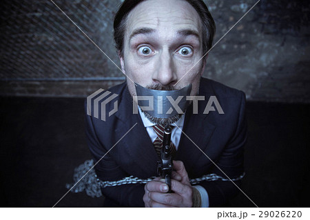 Horrified businessman desperate to escape from 29026220