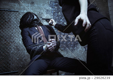 Dangerous fierce kidnapper yelling at the hostage 29026239