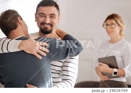 Joyful bearded man enjoying time with his 29026704