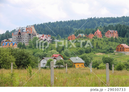 Modern cottages on slopes of forested mountains Modern cottages on slopes of forested mountains 29030733