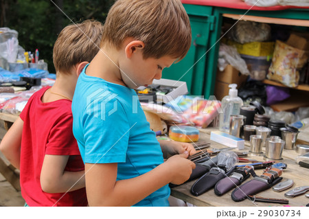 Two boys looking at souvenirs in market Two boys looking at souvenirs in market 29030734