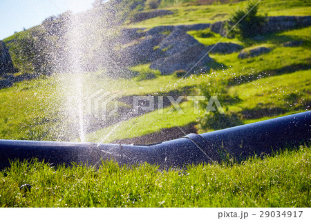 Water splashes under pressure from  damaged pipe 29034917