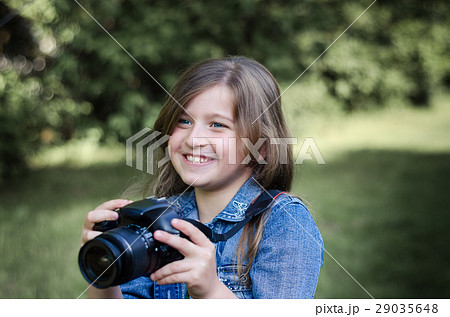 Happy beautiful little girl with photocamera. 29035648