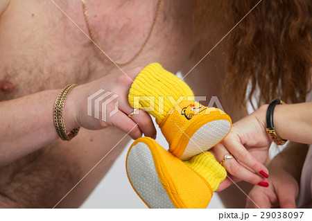 pregnant woman and man with baby socks pregnant woman and man with baby socks 29038097