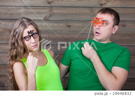 Playful couple with funny glasses on a sticks Playful couple with funny glasses on a sticks 29046832