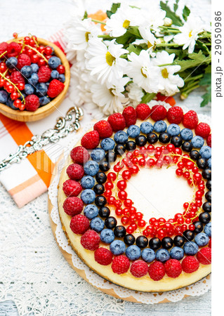 Raspberry and blueberry cheesecake on wooden table 29050986