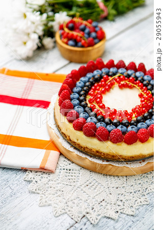 Raspberry and blueberry cheesecake on wooden table Raspberry and blueberry cheesecake on wooden table 29055943
