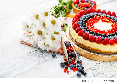 Raspberry and blueberry cheesecake on wooden table 29055946